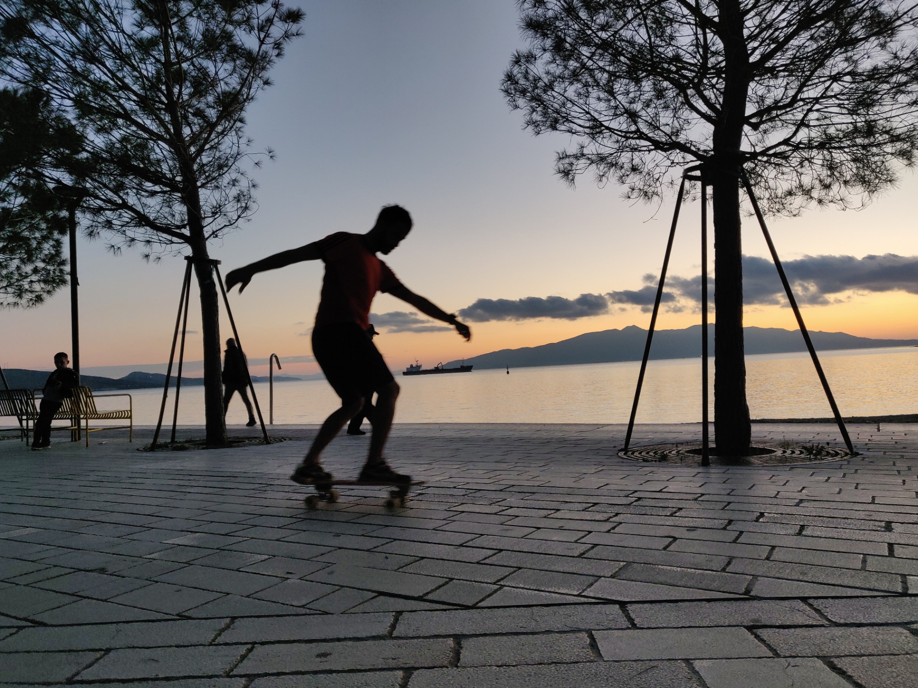 Surfskate silhouette at sunset along the Sarandë boulevard